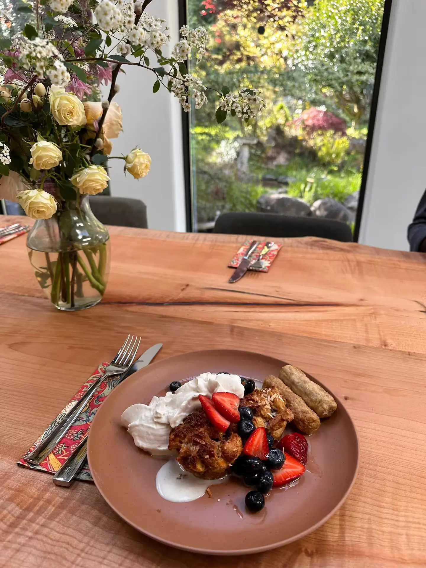 A beautifully presented plate of food sits atop a wooden table, highlighting the textures and colors of the dish.